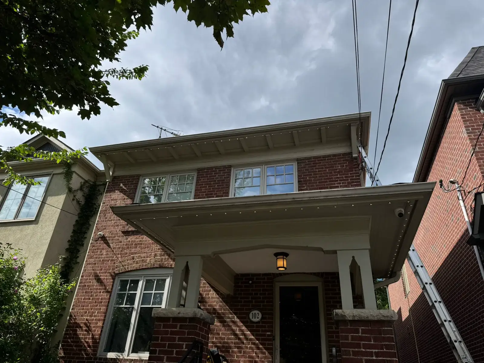 Permanent LED lighting track installed along a porch soffit on a GTA home