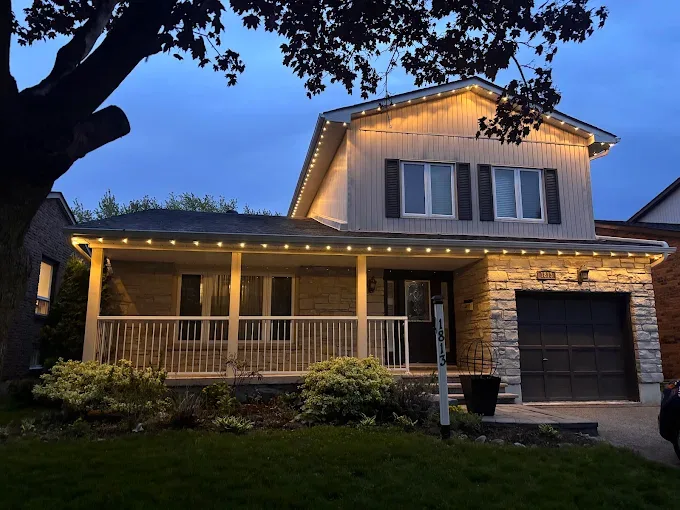 Two-storey GTA home with approximately 300 warm white permanent outdoor LED lights along the roofline and covered porch, installed by Toronto Glow
