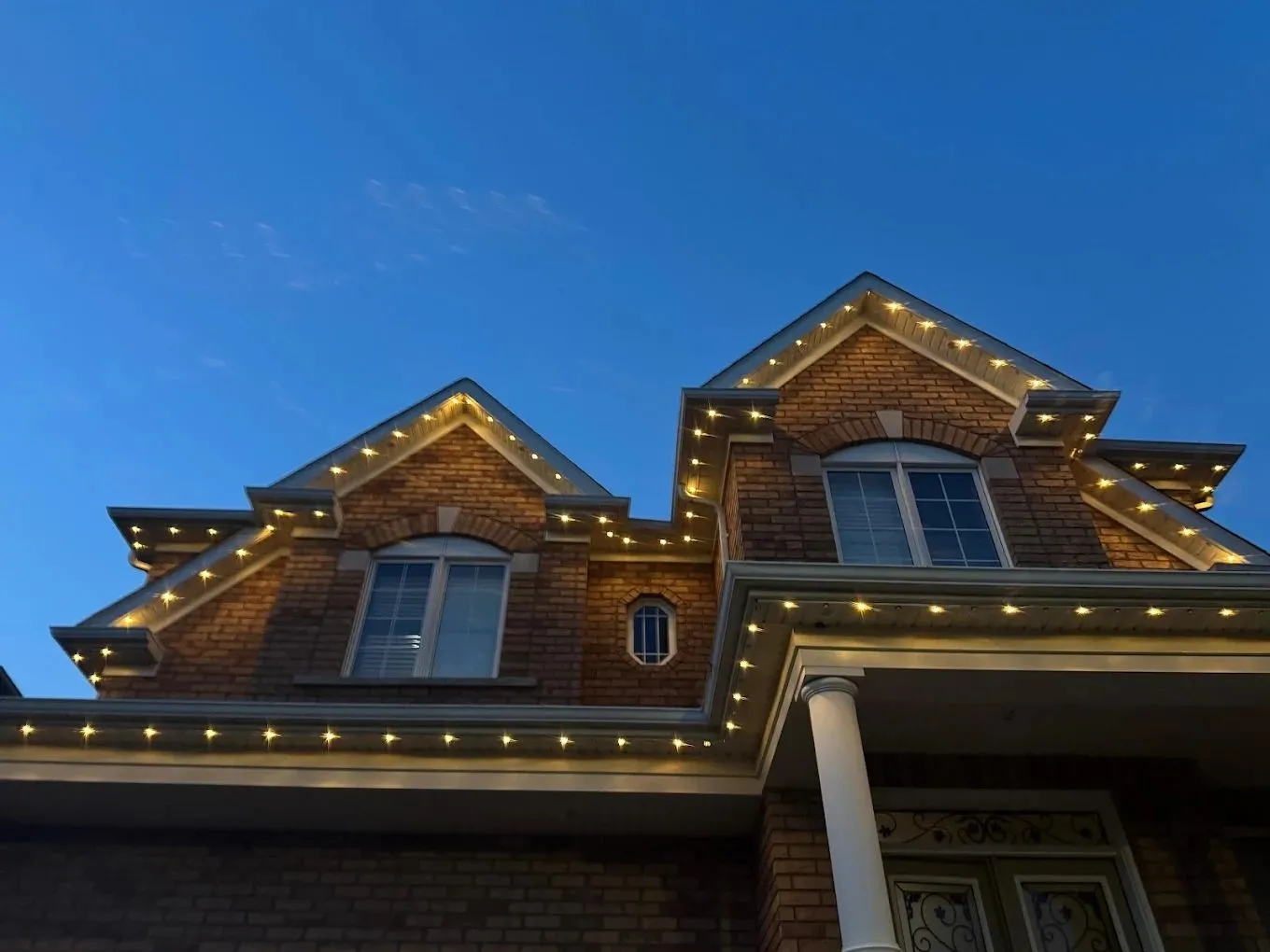 GTA home with permanent outdoor LED lighting in warm white at night