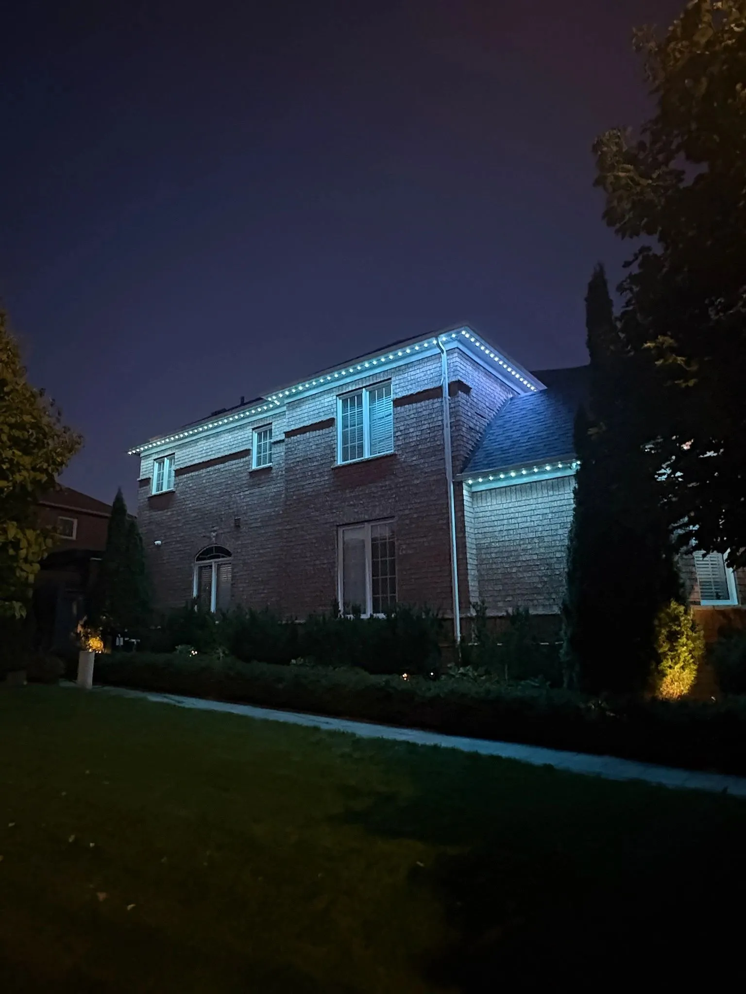 GTA home with permanent outdoor LED lighting in warm white at night installed by Toronto Glow