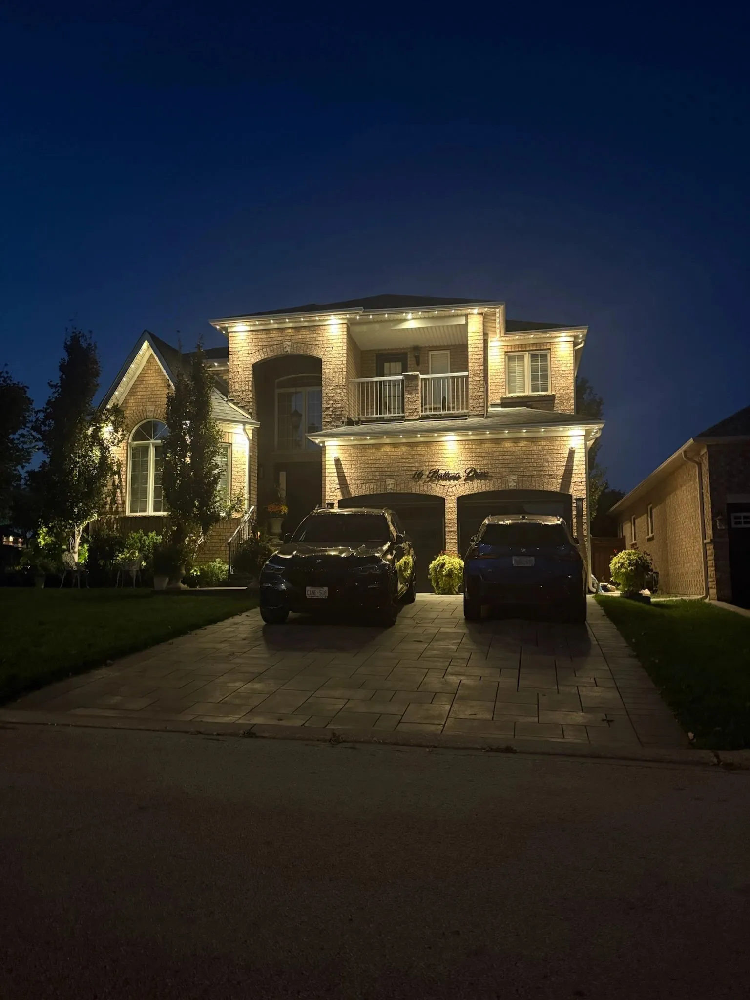 Large GTA home with permanent soffit lighting in warm white at night installed by Toronto Glow