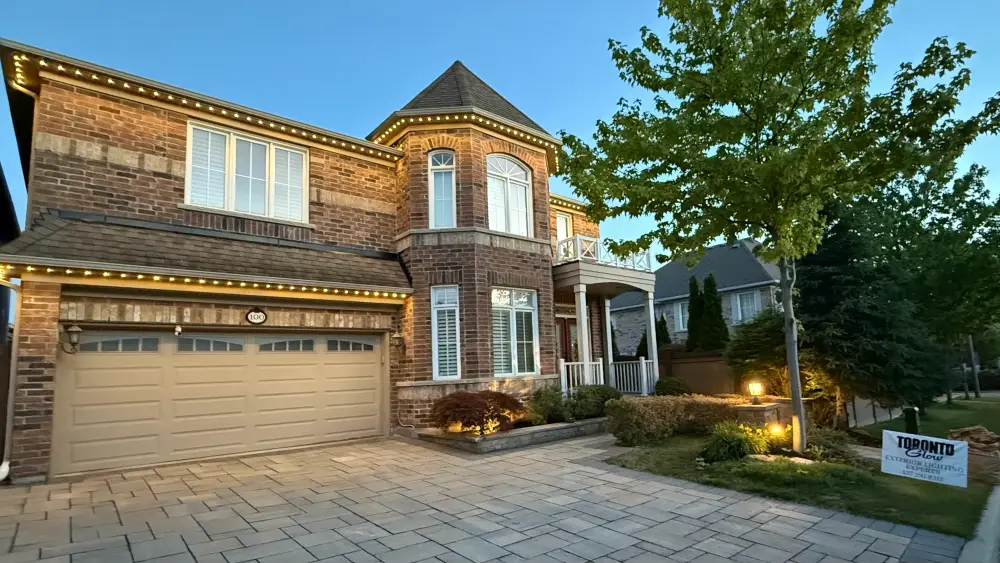 GTA brick home with permanent outdoor LED lighting in warm white at dusk