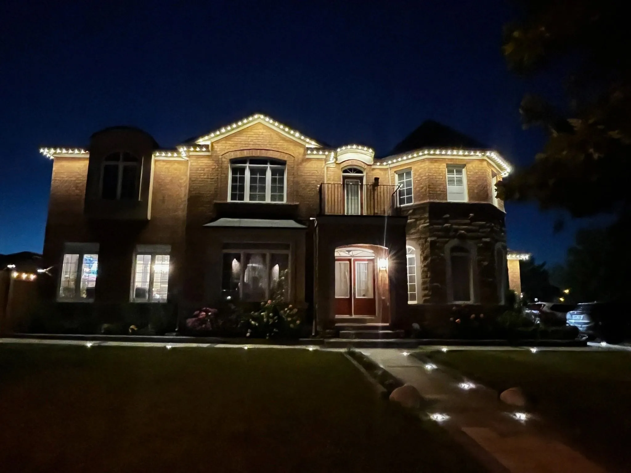 GTA luxury home with permanent soffit lighting in warm white installed by Toronto Glow