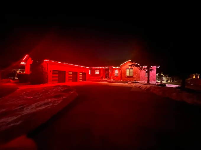 GTA bungalow with permanent Christmas lights in red in winter snow installed by Toronto Glow
