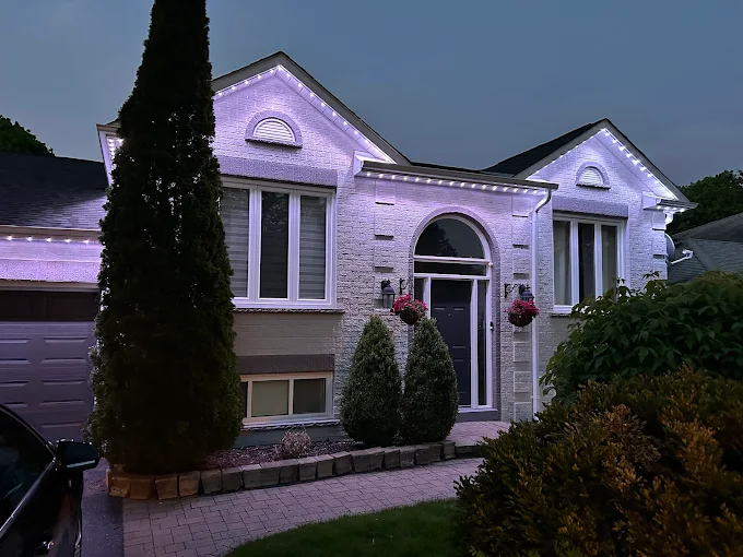 GTA home with white and purple permanent LED roofline lighting by Toronto Glow