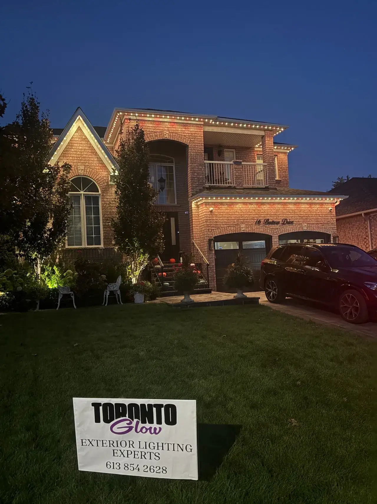 GTA home with permanent Christmas lights installed by Toronto Glow, showing warm white and orange LEDs along the roofline at dusk.