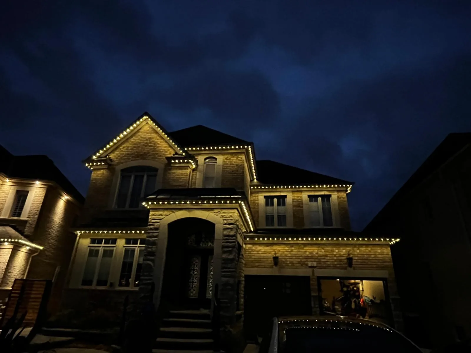 GTA home with warm white permanent LED roofline lighting by Toronto Glow