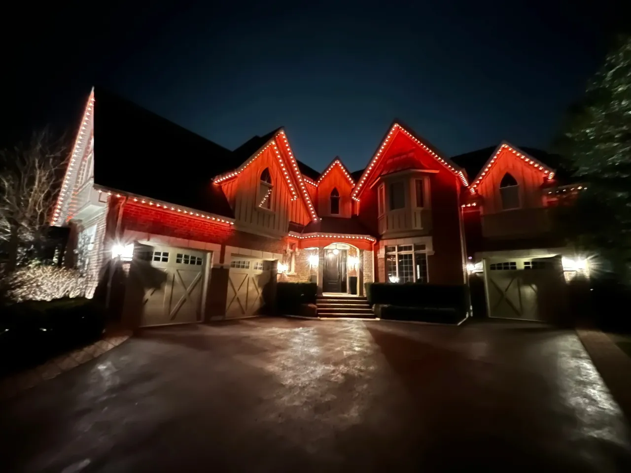 Halton Hills home lit with red permanent outdoor LED lights, using about $8 per month in electricity.