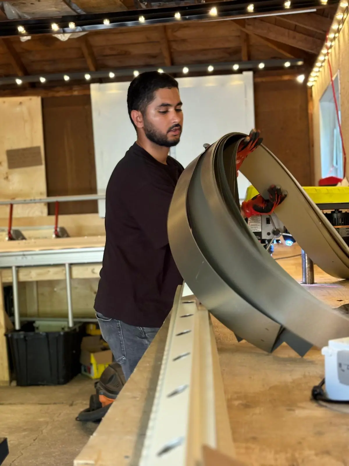 Toronto Glow team member handling Ontario aluminum flat-stock roll