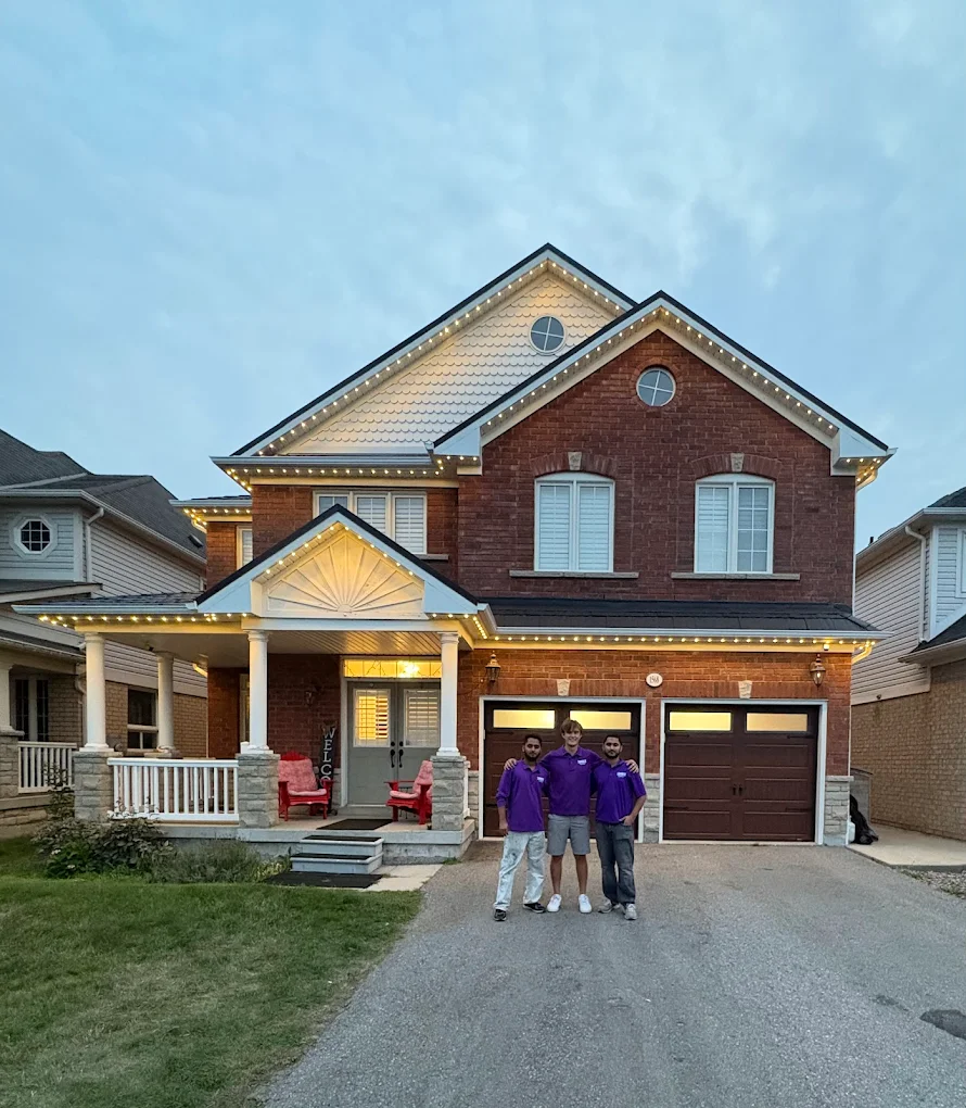 Toronto Glow installation team in front of a GTA home with permanent LED lighting at dusk