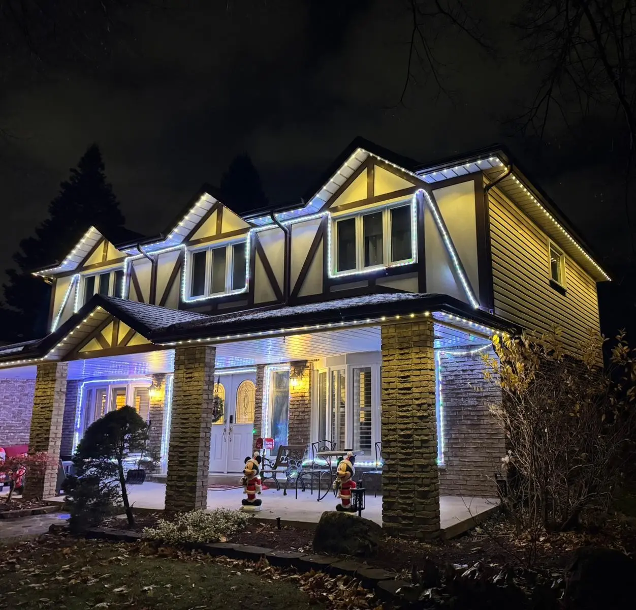GTA home lit up with permanent Christmas lights installed by Toronto Glow — featuring multicolour LED soffit and roofline lighting controlled from a smartphone app.