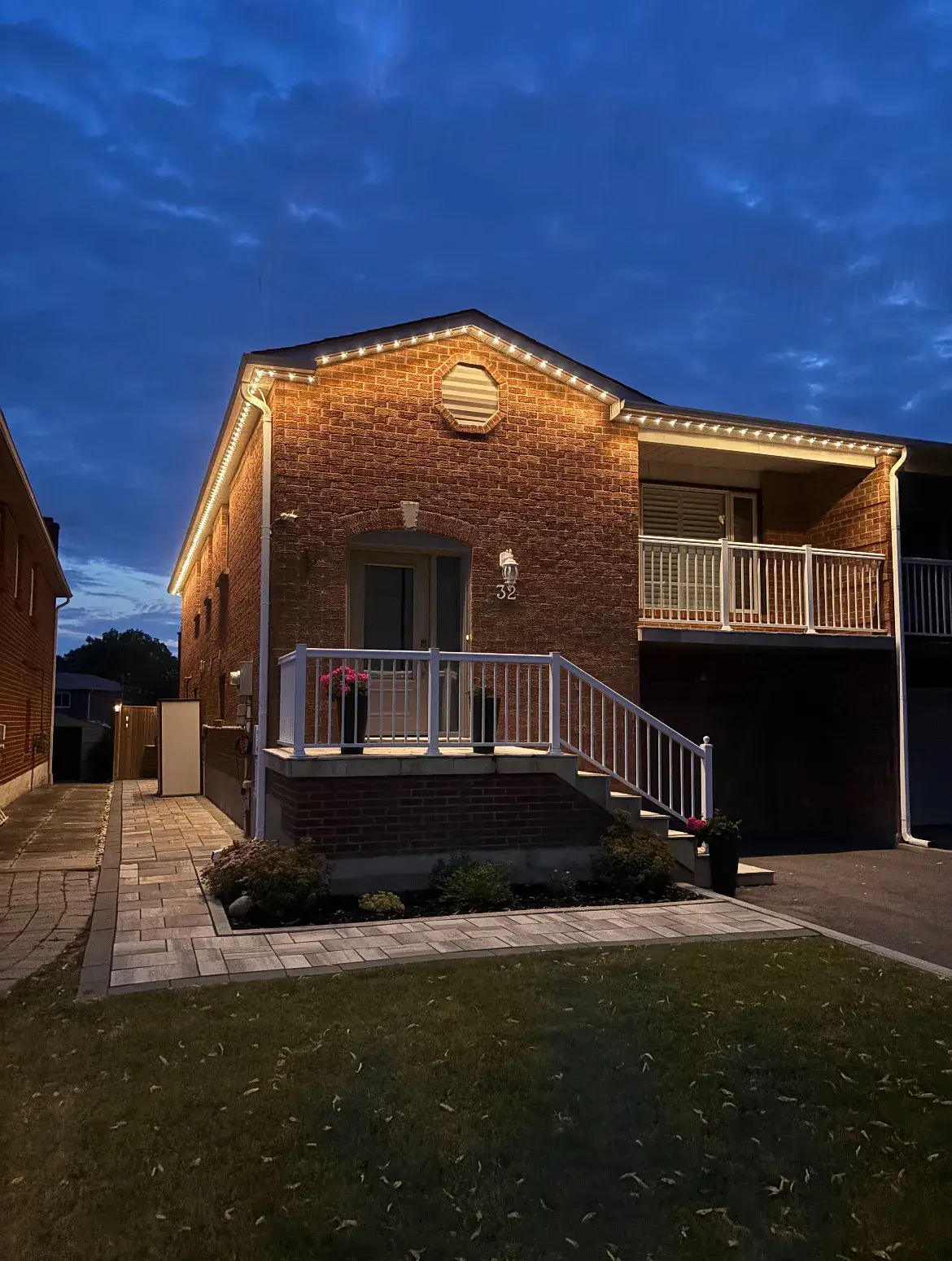GTA home lit with warm white permanent Christmas lights by Toronto Glow — LEDs mounted along the roofline and soffit, glowing brilliantly against the night sky.